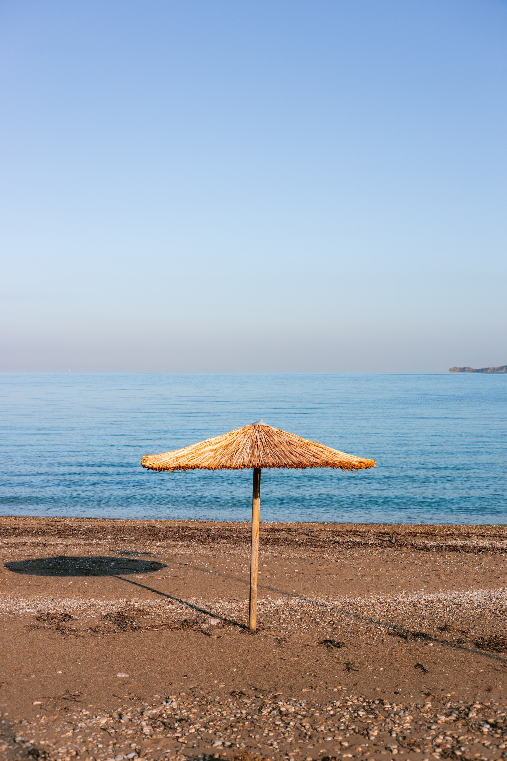 Straw Umbrella Beach View by HelloHappylife — canvas wall art
